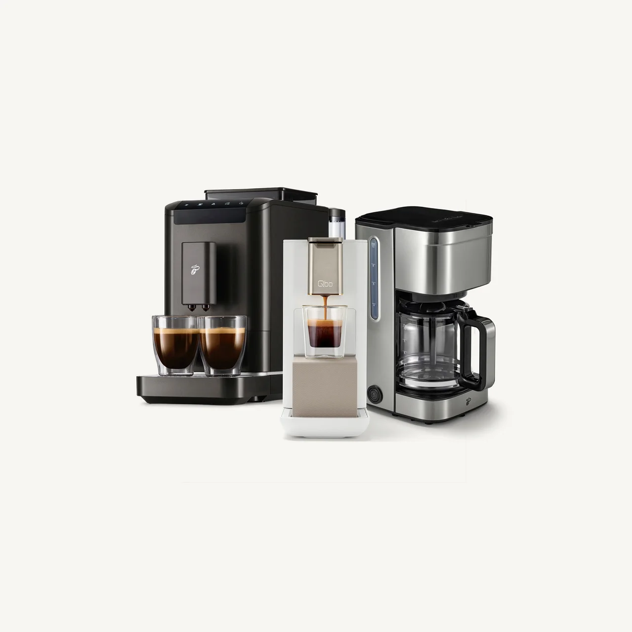 Drei Kaffeemaschinen: ein dunkelgrauer Vollautomat mit zwei Tassen, eine weiß-beige Kapselmaschine mit einer Tasse und eine silberne Filterkaffeemaschine.