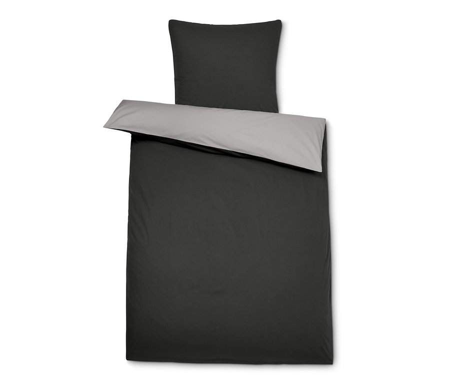 Ein schwarzes Perkal-Bettwäsche-Set mit einer grauen Innenseite, die auf der Decke umgeschlagen ist, und einem grauen Kissen oben drauf.