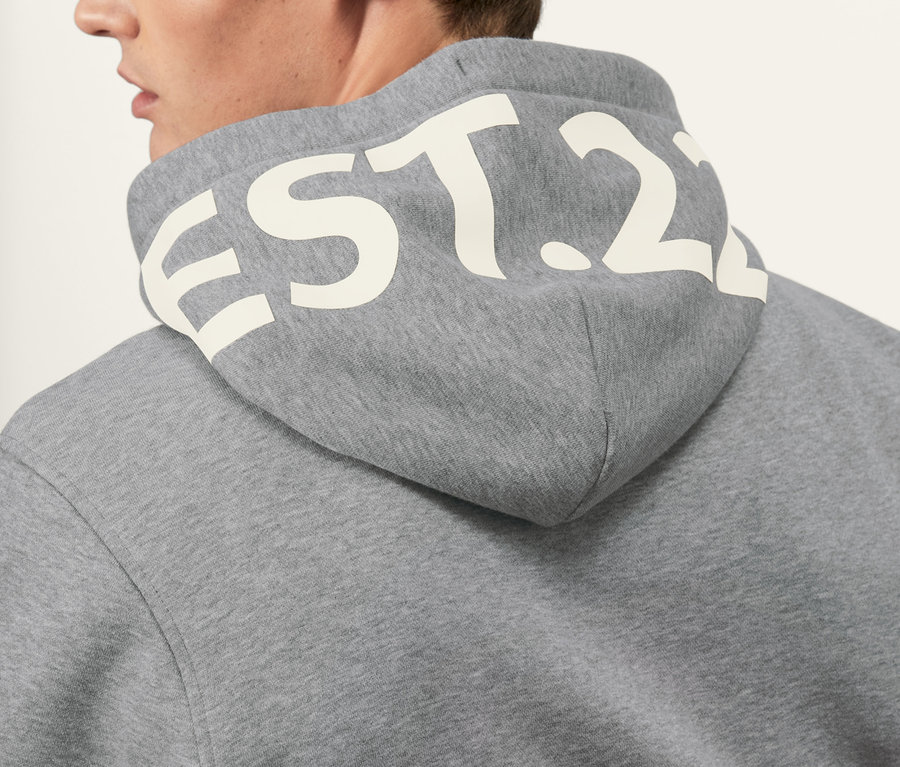 Mann trägt grauen Hoodie.