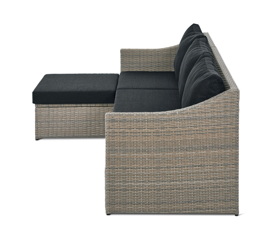 Graues Lounge-Schlafsofa »Thore« mit Ausziehfunktion und schwarzen Kissen.