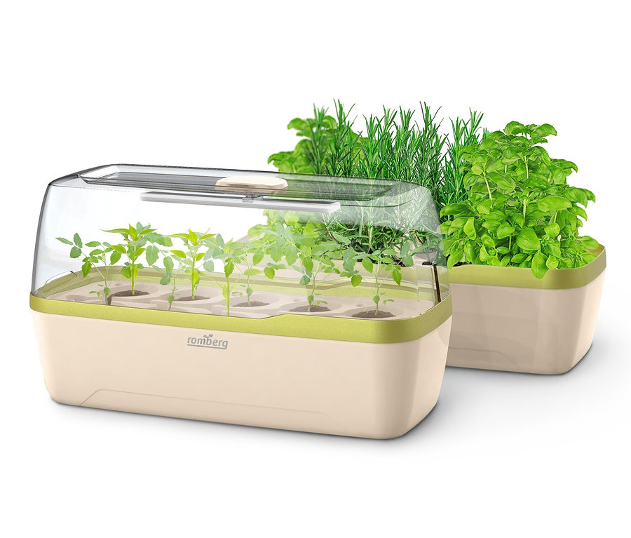 Smart-Indoorgarten-Set mit wachsenden Pflanzen drinnen.