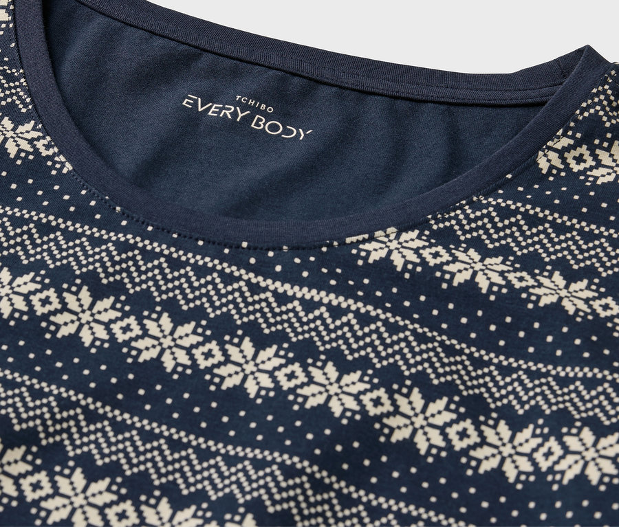 Detail eines dunkelblauen T-Shirts mit weißem Norwegermuster.