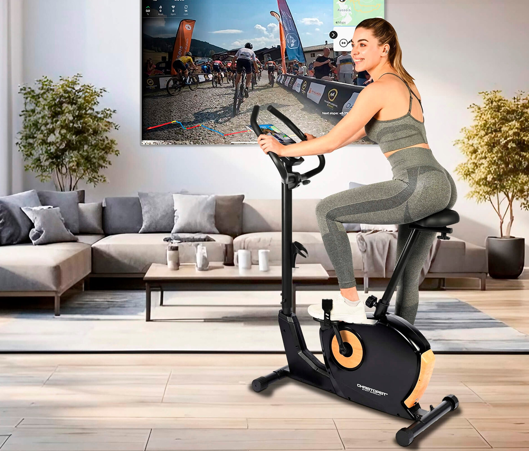 Frau trainiert auf Heimtrainer Ergometer »ET 3.1« vor dem Fernseher.