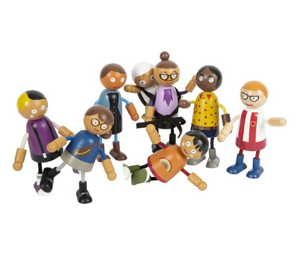 Acht Biegepuppen der small foot Biegepuppen-Familie mit Baby stehen und liegen auf dem Boden.