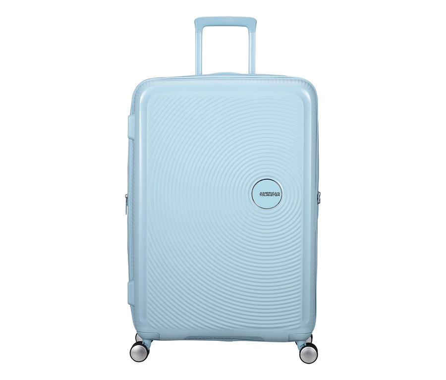 Großer American Tourister Soundbox Hartschalen-Koffer in Pastellblau mit Spinner-Rädern, ausgefahrenem Griff und konzentrischem Kreismuster.