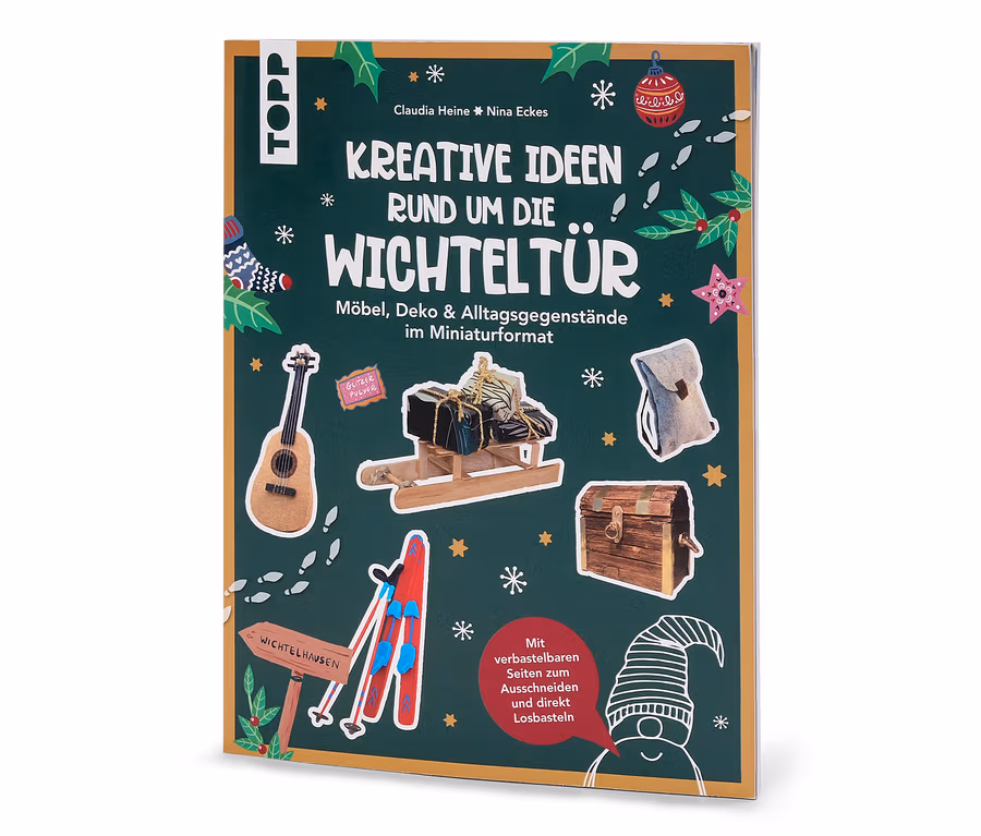 Das Buch »Kreative Ideen rund um die Wichteltür« zeigt auf dem Cover Miniaturen von Möbeln und Dekorationen auf grünem Hintergrund.