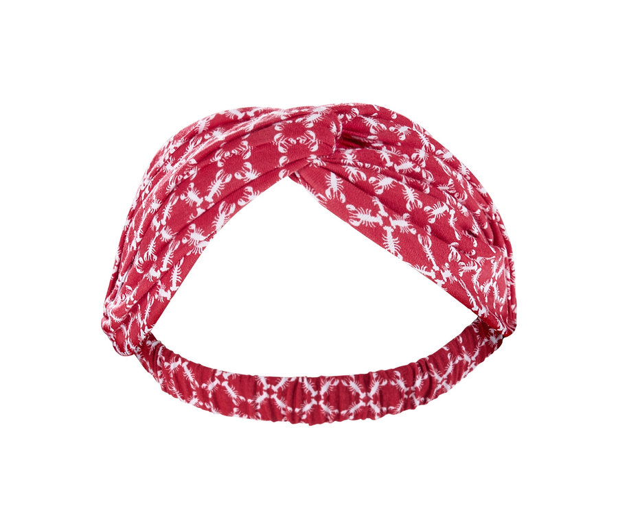 Ein rotes Haarband mit weißem Muster.
