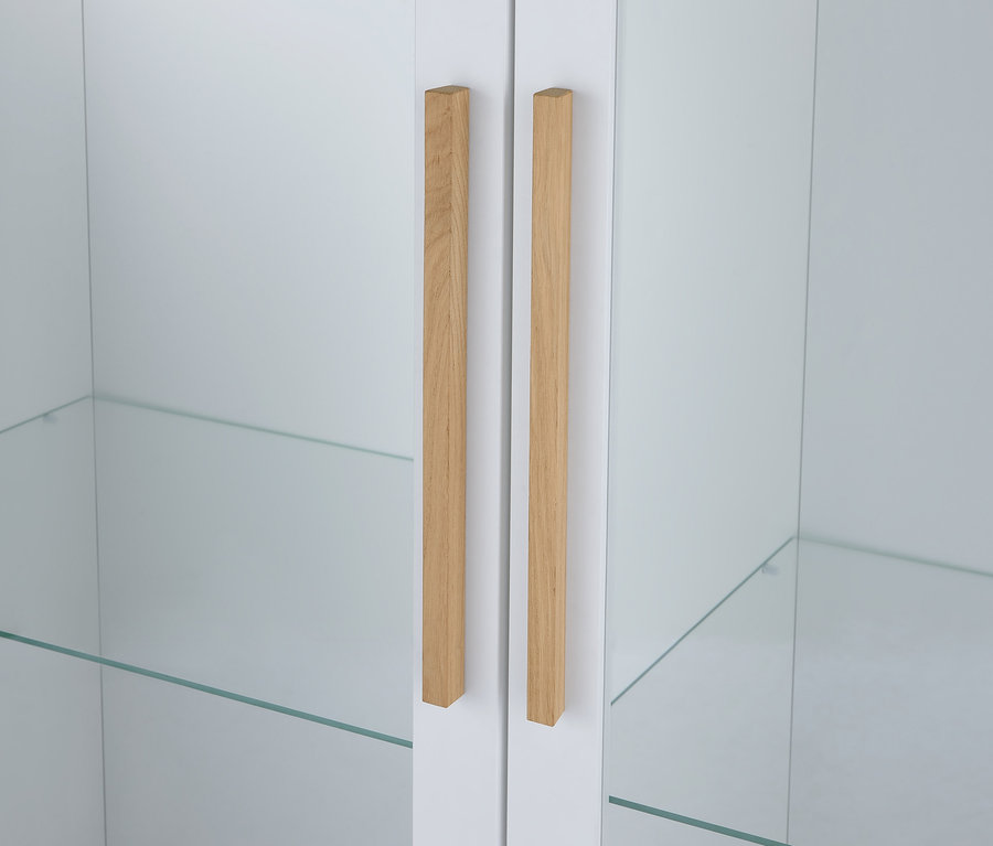 Detail einer weißen Vitrine »Eklund« mit zwei Glastüren und Holzgriffen.
