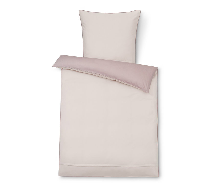 Beige TENCEL™-Baumwollbettwäsche mit rosa Bordüre und Kissen.