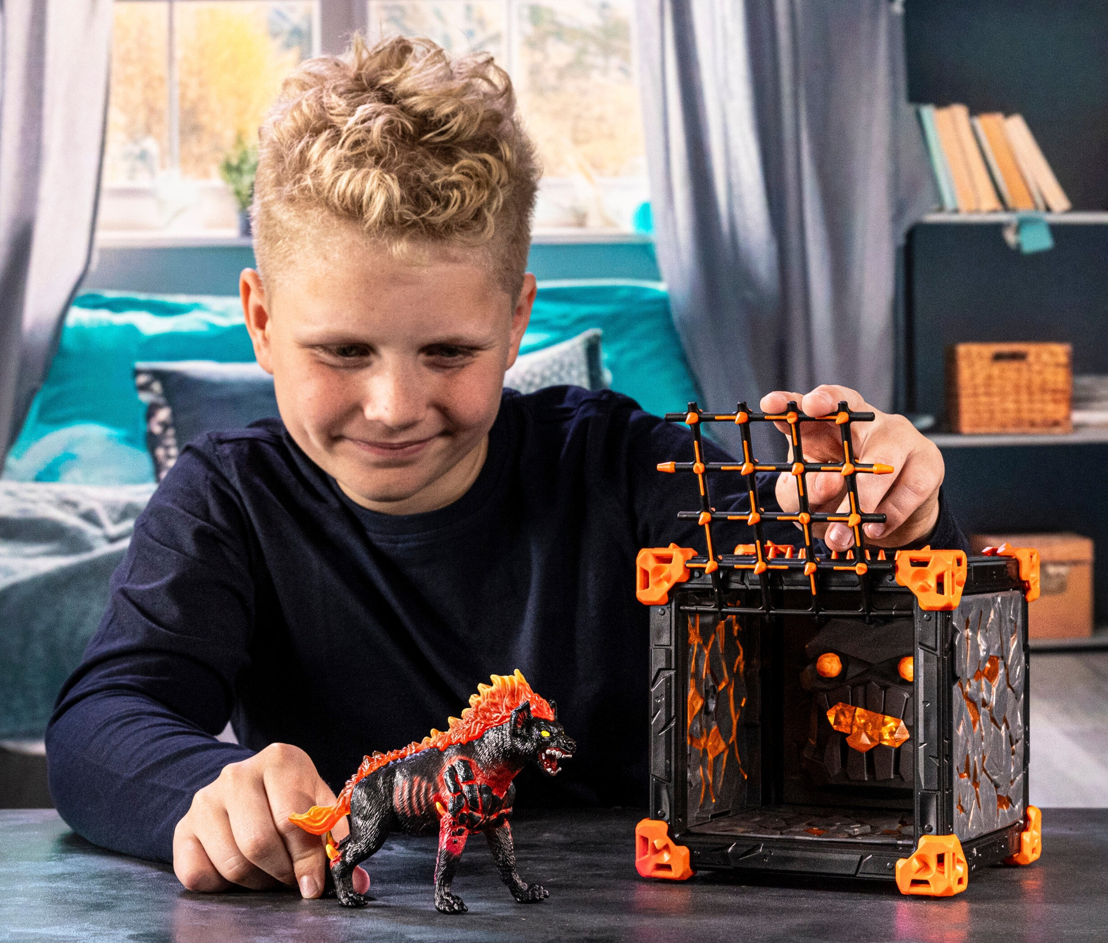 Ein Junge spielt mit der Schleich Eldrador BattleCave Lavahyäne und der Schleich Eldrador BattleCave.