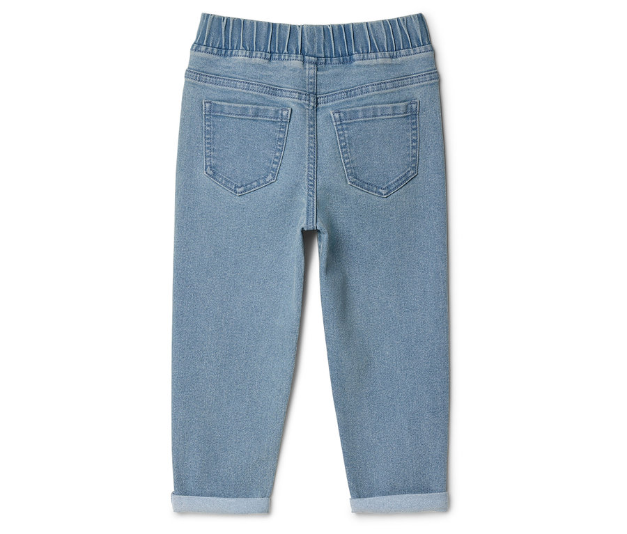 Rückansicht einer hellblauen Jeans mit elastischem Bund und hochgekrempelten Hosenbeinen.