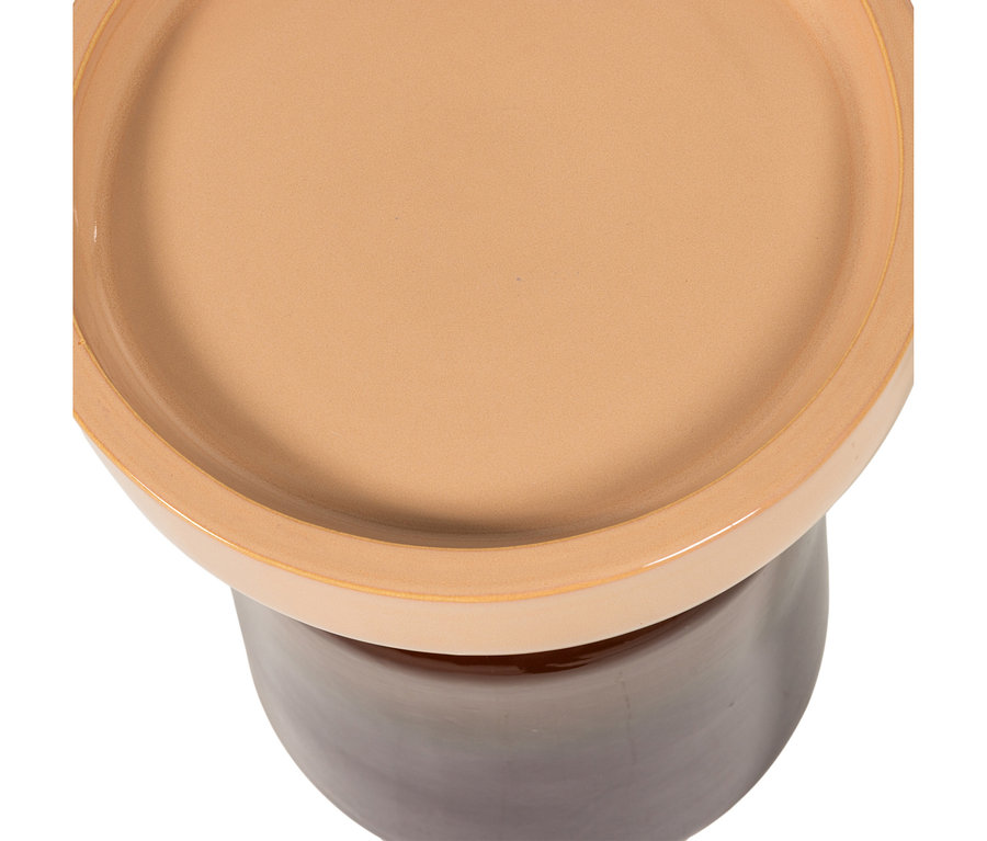 Zweifarbiger Keramik-Pflanztopf oder Ständer, von oben gesehen. Er hat eine runde, hellbeige Oberseite mit erhöhtem Rand und eine dunkelbraune, sich verjüngende Basis.