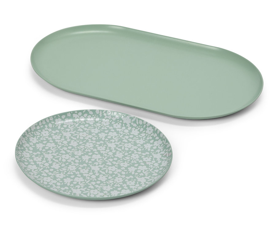 Ein ovaler, hellgrüner Teller neben einem runden Teller mit hellgrünem Muster.