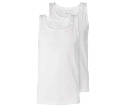 Zwei weiße Tanktops liegen übereinander.