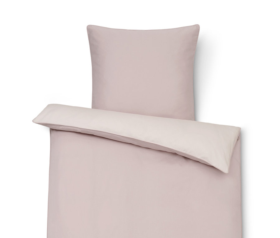 Rosa TENCEL™-Baumwollbettwäsche mit Kopfkissen.
