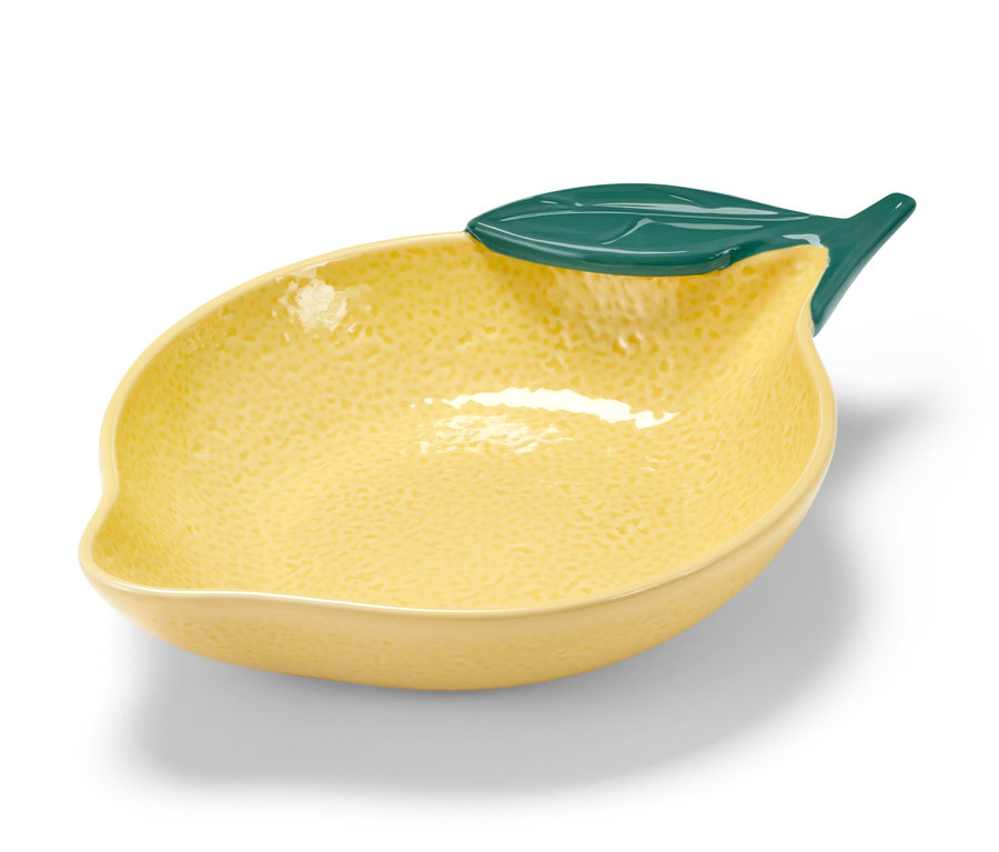 Gelbe Schale in Zitronenform mit grünem Blatt.