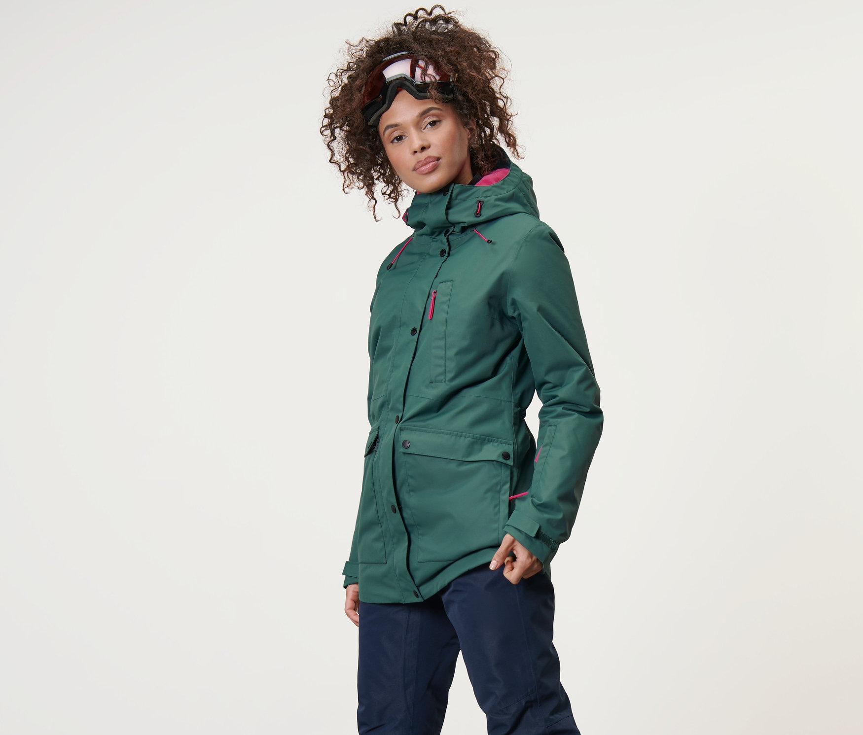 Frau trägt eine Ski-und-Snowboardjacke und Skihose.