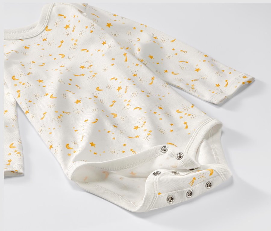 Detailansicht eines mitwachsenden Baby-Bodys mit Sternen.
