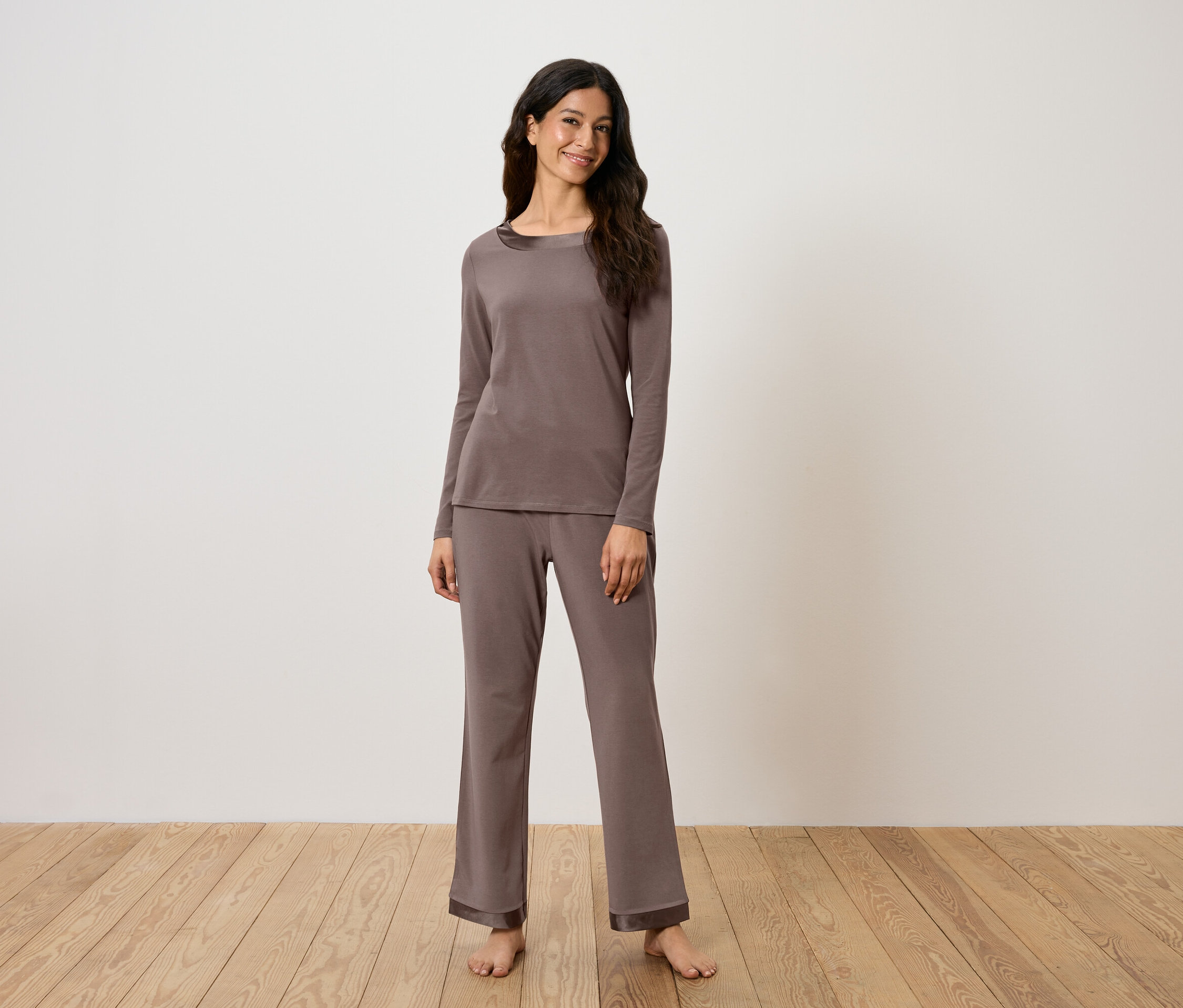 Frau trägt einen braunen, langärmligen Pyjama.