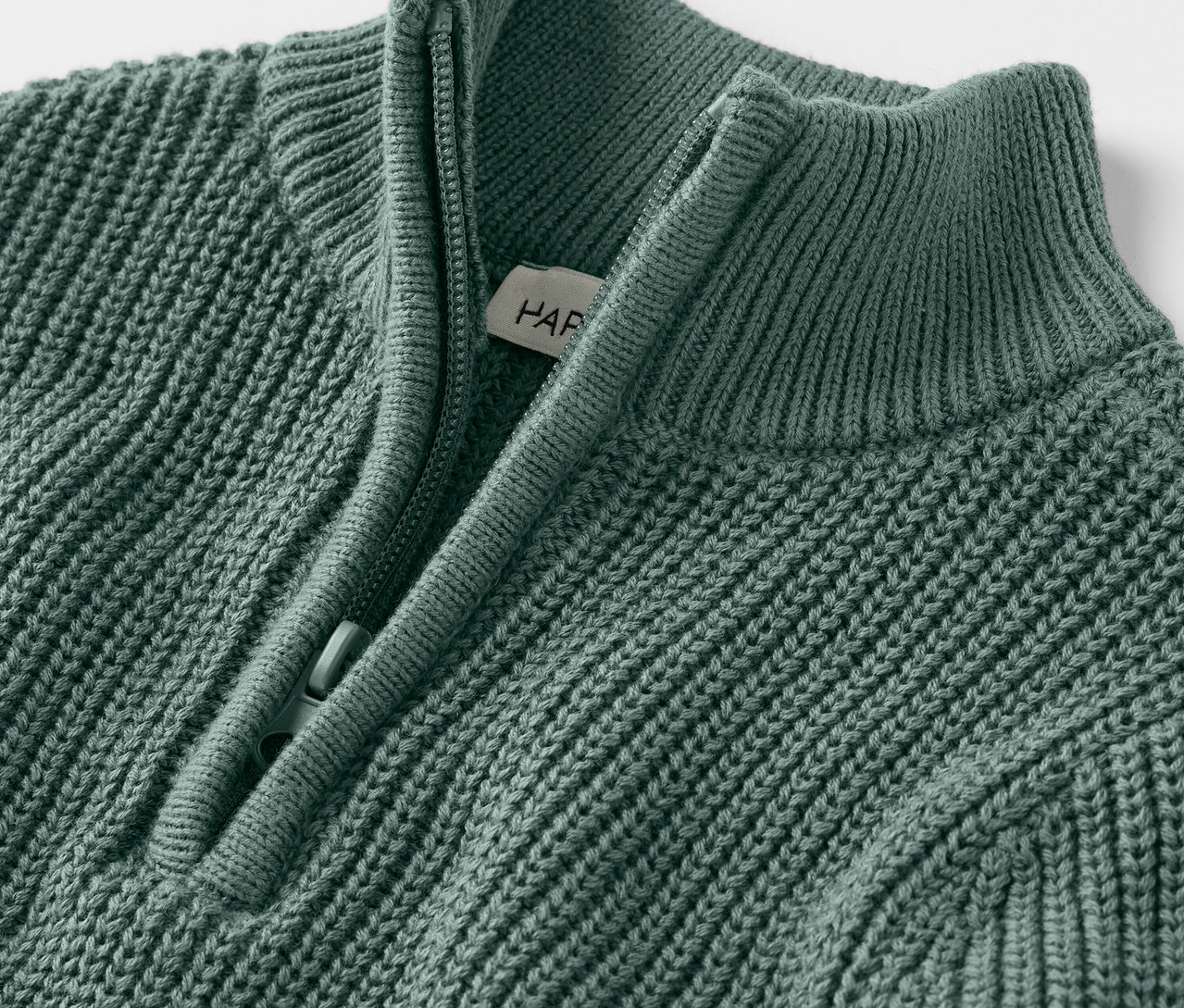 Nahaufnahme eines Kinder-Strick-Troyers mit kurzem Reißverschluss.