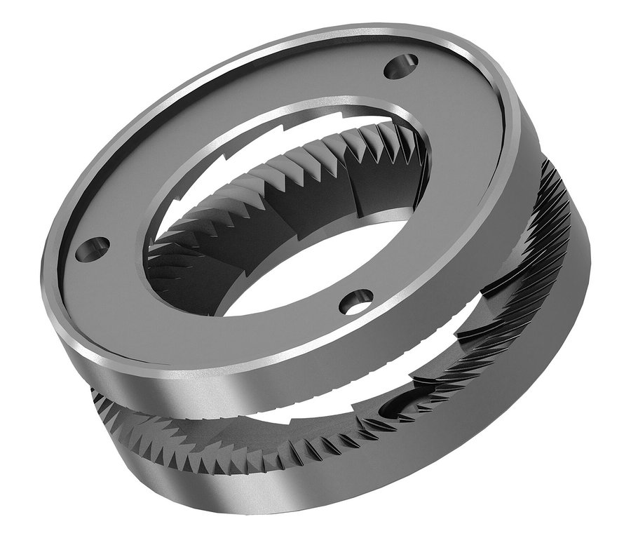 Zwei graue Mahlwerksteile mit gezackten Kanten und Löchern liegen übereinander.