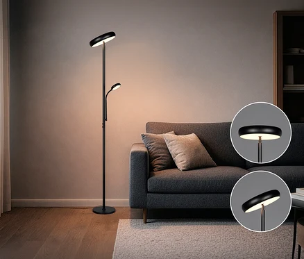 Schwarze Trio Stehleuchte »Palermo« neben einem grauen Sofa mit Kissen auf einem Teppich.