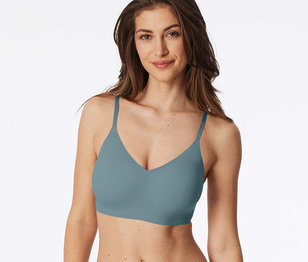 Frau trägt einen blaugrünen BH und Unterwäsche.