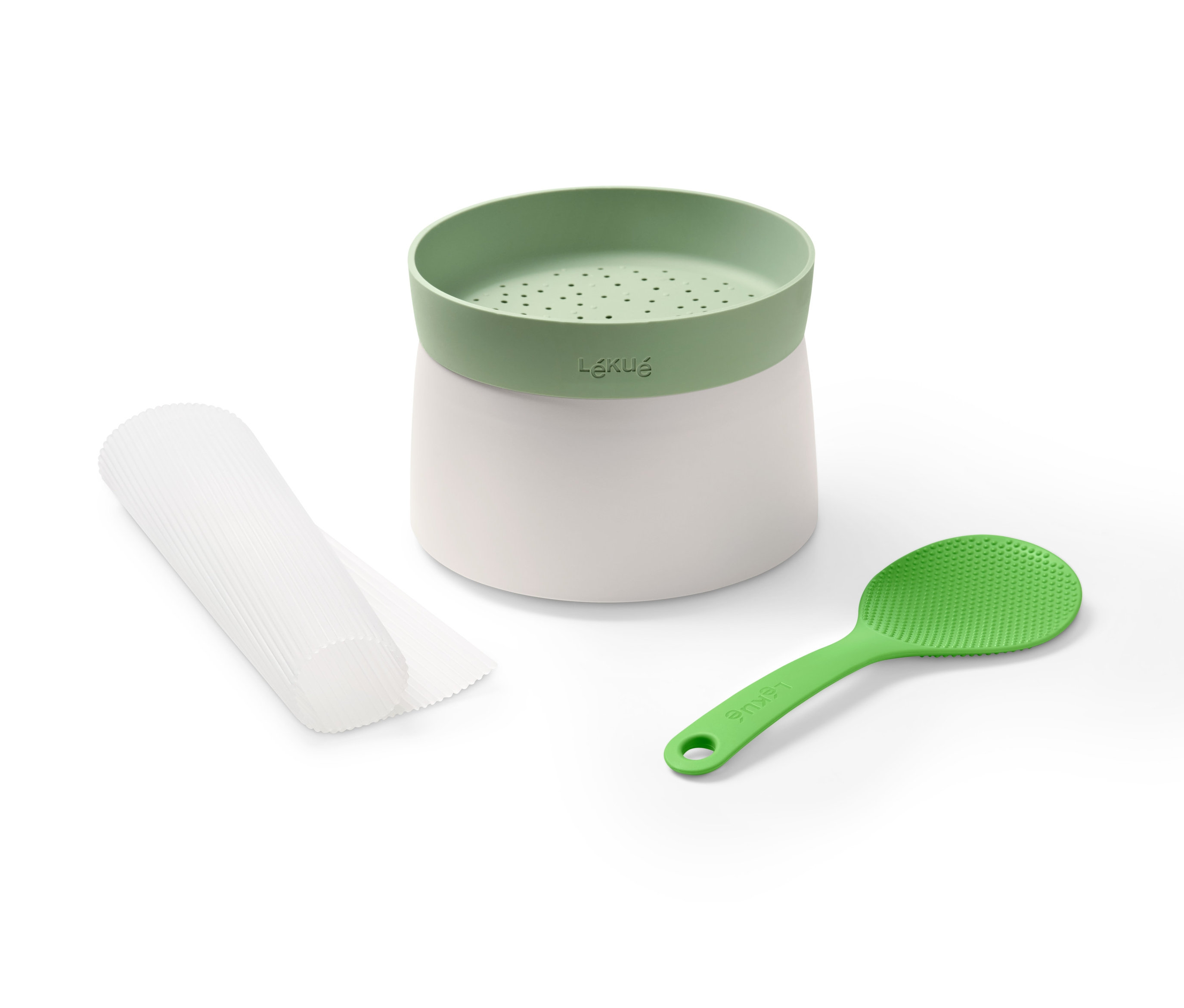 Lékué Sushi-Set mit weißem Behälter, grünem Oberteil und Löffel sowie weißen Verpackungen.
