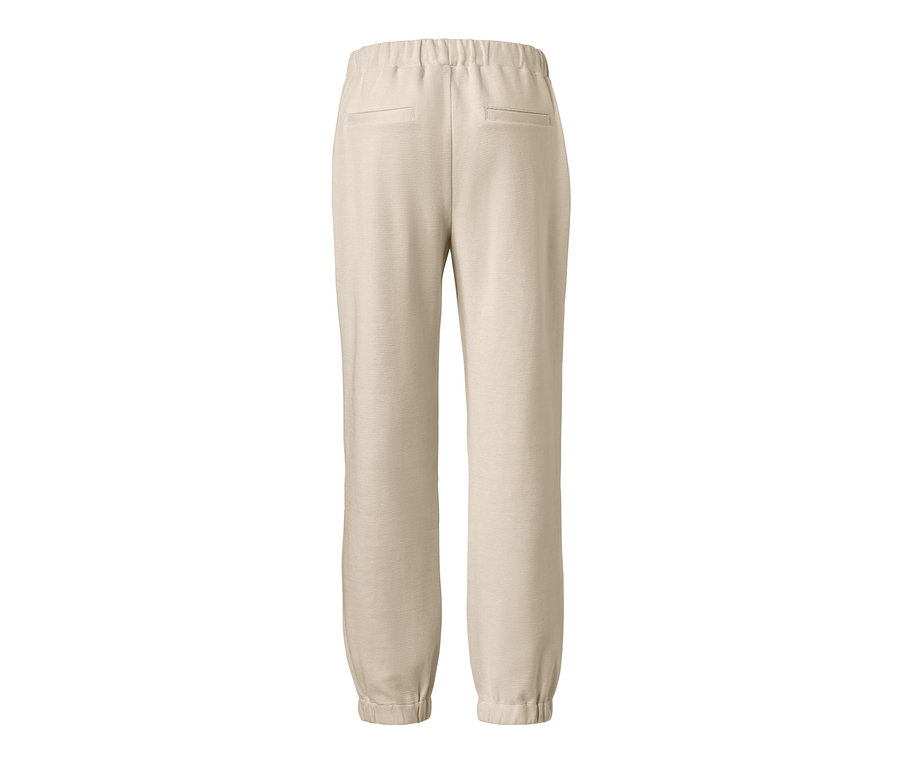 Knöchellange Joggpants in Beige von hinten.