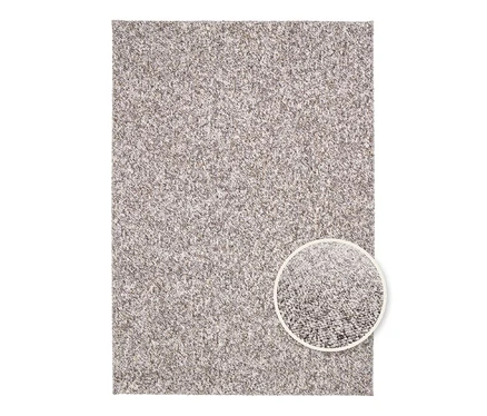 Detailansicht eines beigen Teppichs "Lino" mit einem kleinen runden Ausschnitt, der die Textur zeigt.
