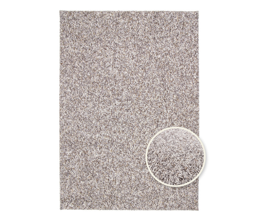 Detailansicht eines beigen Teppichs "Lino" mit einem kleinen runden Ausschnitt, der die Textur zeigt.