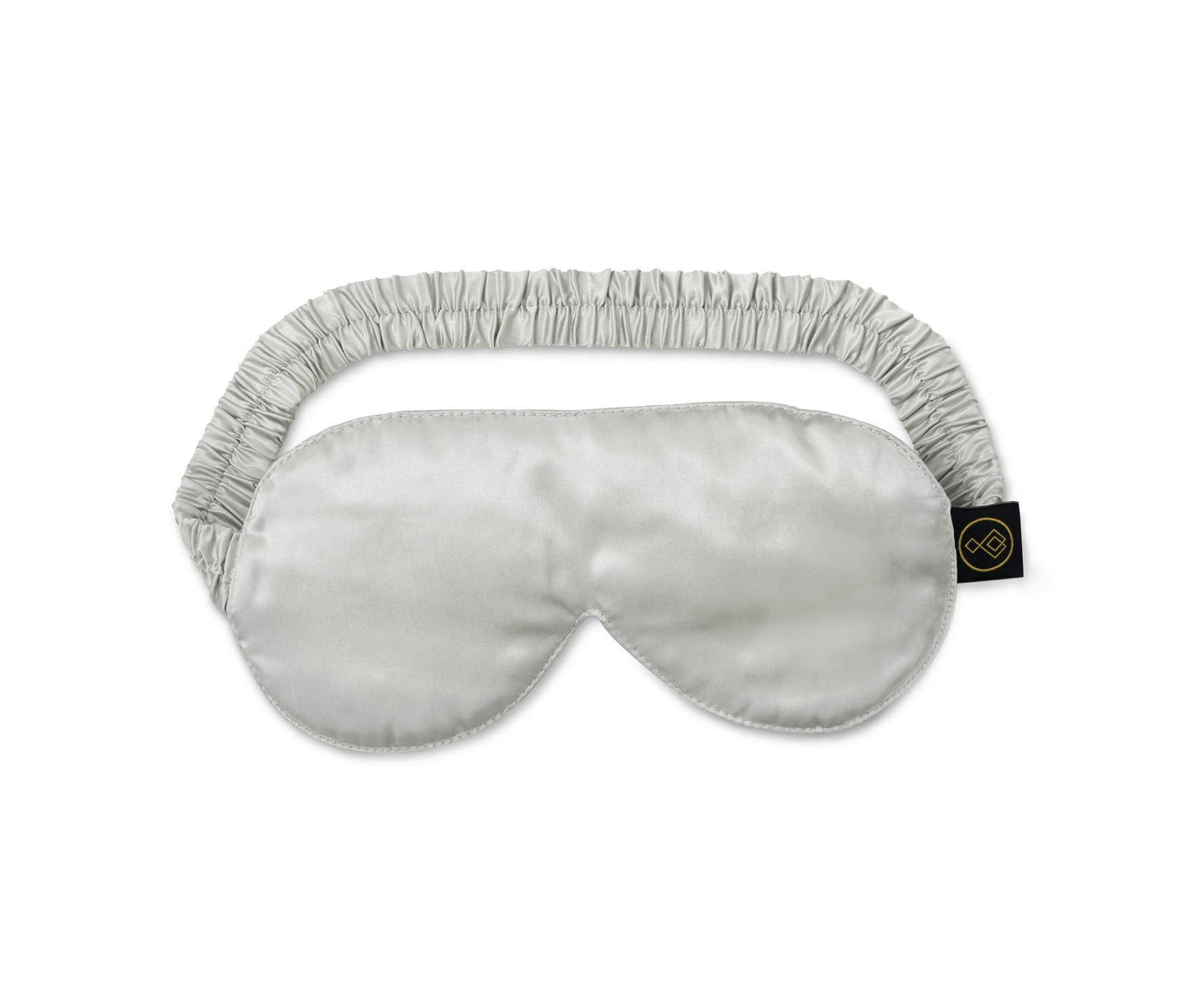 Eine silberne Seiden-Schlafmaske mit einem elastischen Zugband.