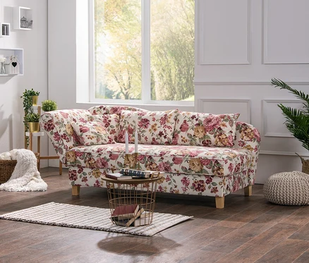 Wohnzimmer mit weißem Bücherregal und blumiger Max-Winzer®-Recamiere »Saturn« mit Stauraum.