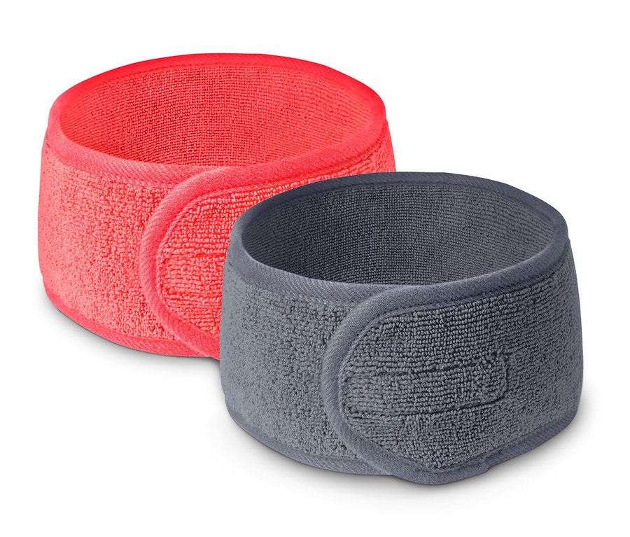 Zwei Kosmetik-Stirnbänder: ein korallfarbenes und ein graues.