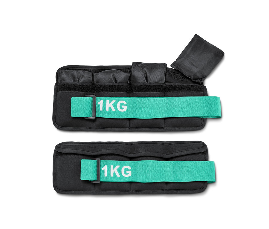 Zwei schwarze Gewichtsmanschetten mit türkisfarbenen Riemen und der Aufschrift 1 kg.