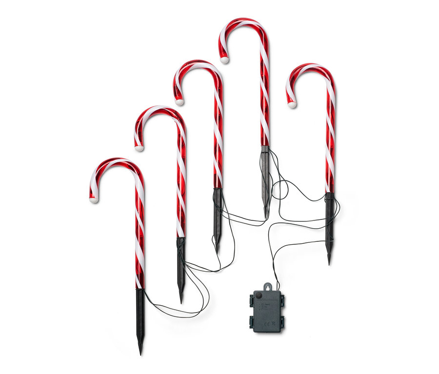 Fünf LED-Zuckerstangen mit rot-weißen Streifen und schwarzen Stäben.