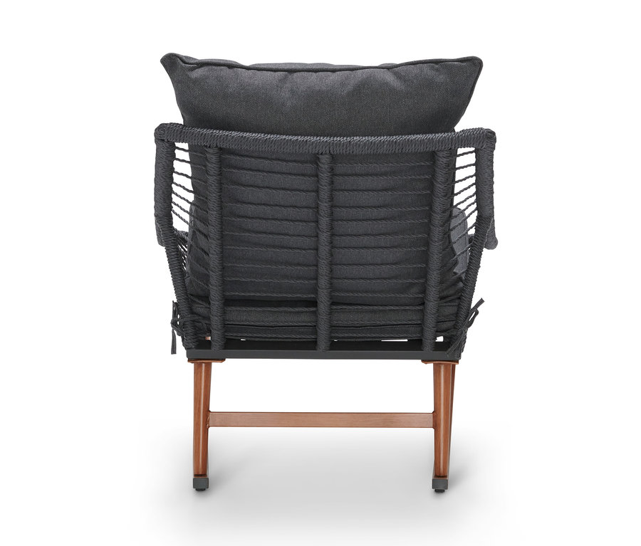 Rückansicht eines Schaukelsessels mit Fußhocker und grauen Kissen.