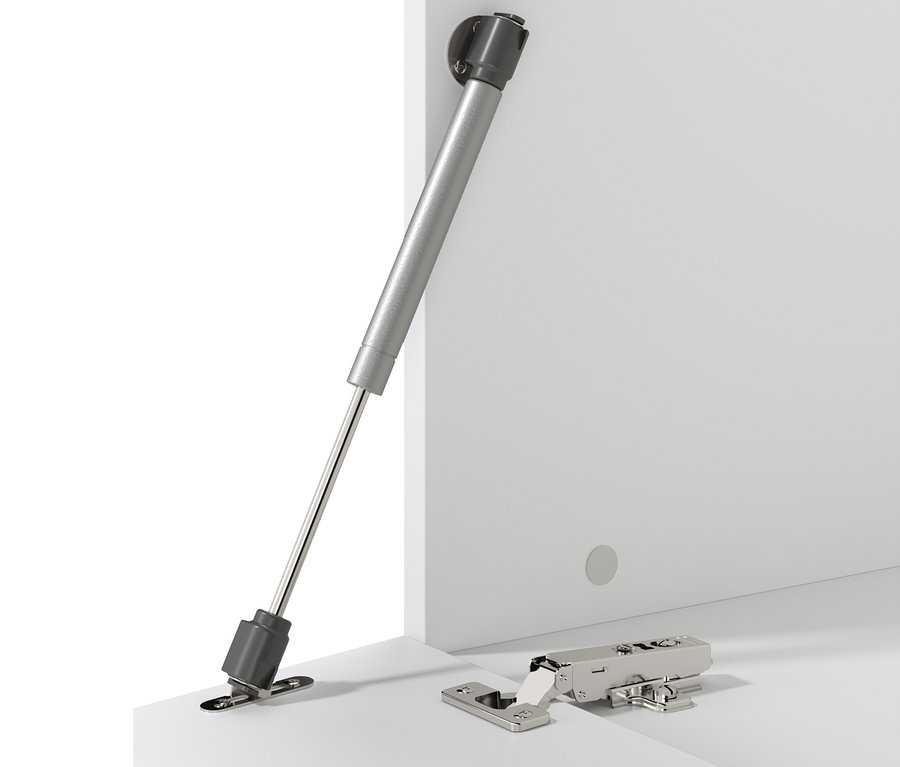 Detail einer silbernen Halterung und eines Scharniers an weißen Möbeln.