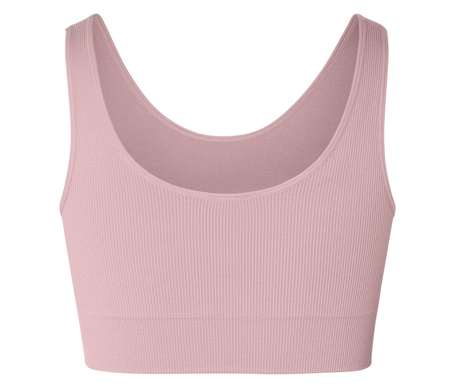 Nahaufnahme eines gerippten, ärmellosen Sport-BHs in Rosa vor einem weißen Hintergrund.