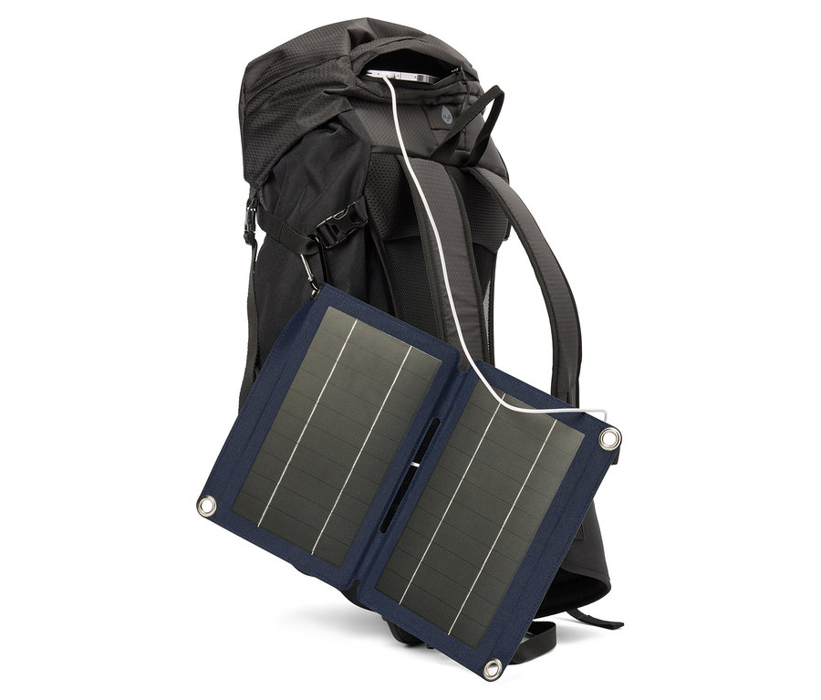Ein schwarzer Rucksack mit einem Solarpanel, das mit einem Kabel verbunden ist.
