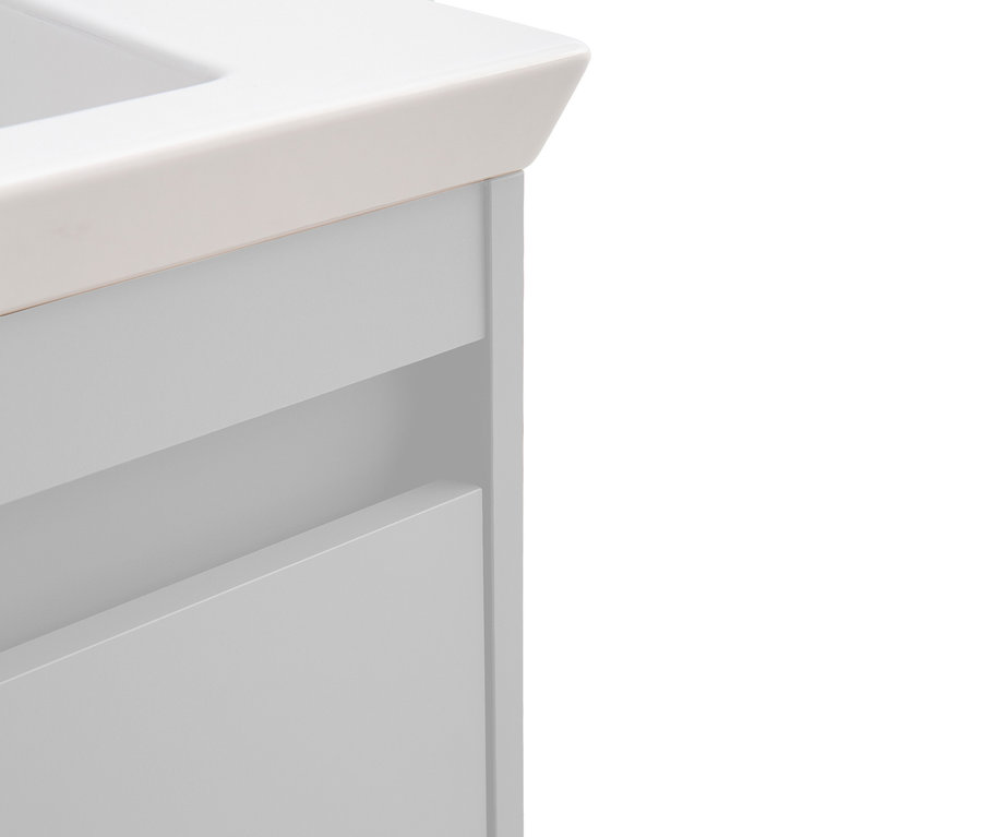 Detailansicht eines grauen Badezimmerschranks mit weißen Akzenten.