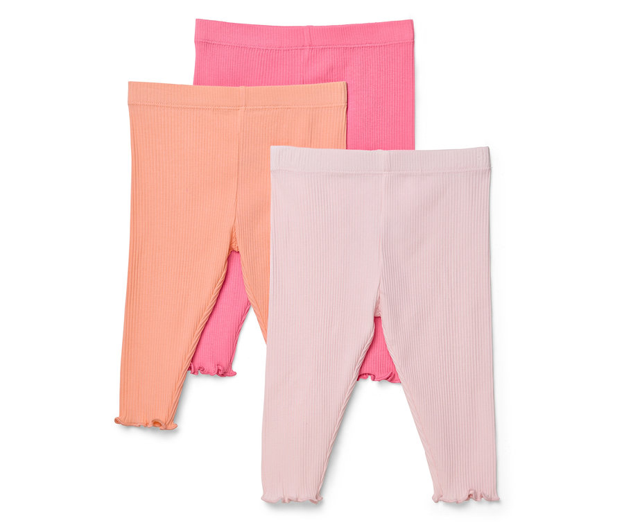 Drei gerippte Leggings in Pink, Orange und Rosa liegen übereinander.