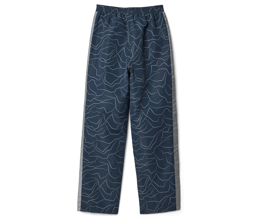 Dunkelblaue Hose mit abstraktem Muster und grauem Seitenstreifen liegt flach.
