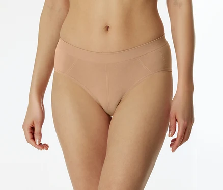 Person trägt hellbeige, nahtlose Slips mit geripptem Bund und subtilen diagonalen Nähten an den Seiten.