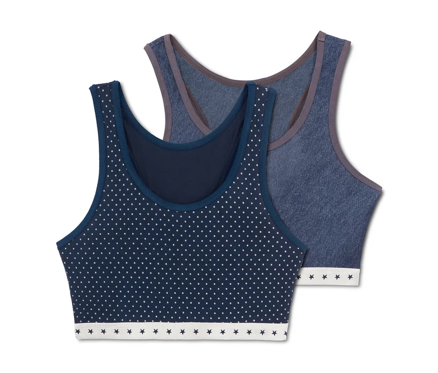 Zwei Mädchen-Bustiers, eines dunkelblau mit weißen Punkten, das andere blau.