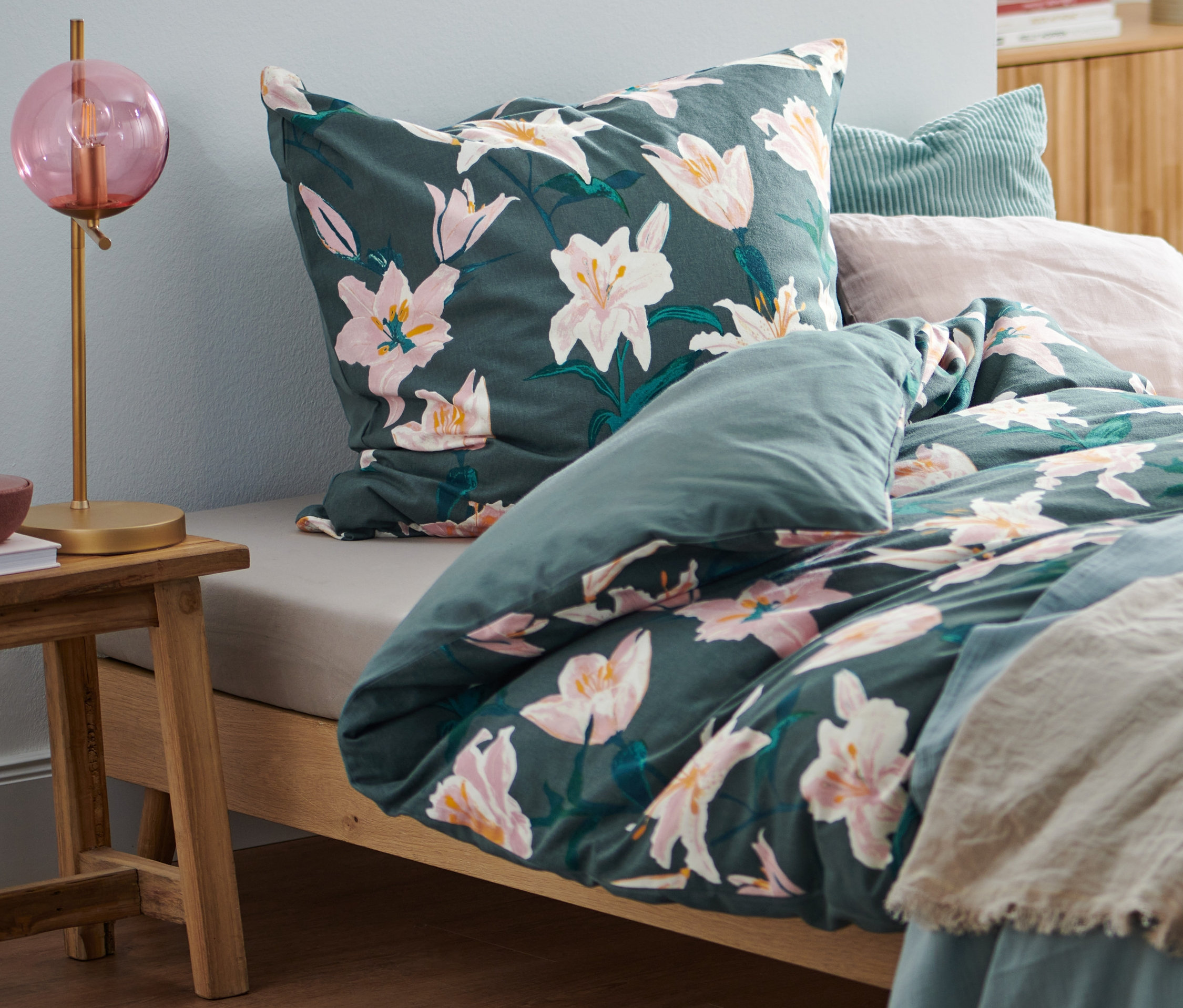 Bett mit Biber-Bettwäsche in Normalgröße, Doppelgröße und Übergröße mit Blumenmuster.