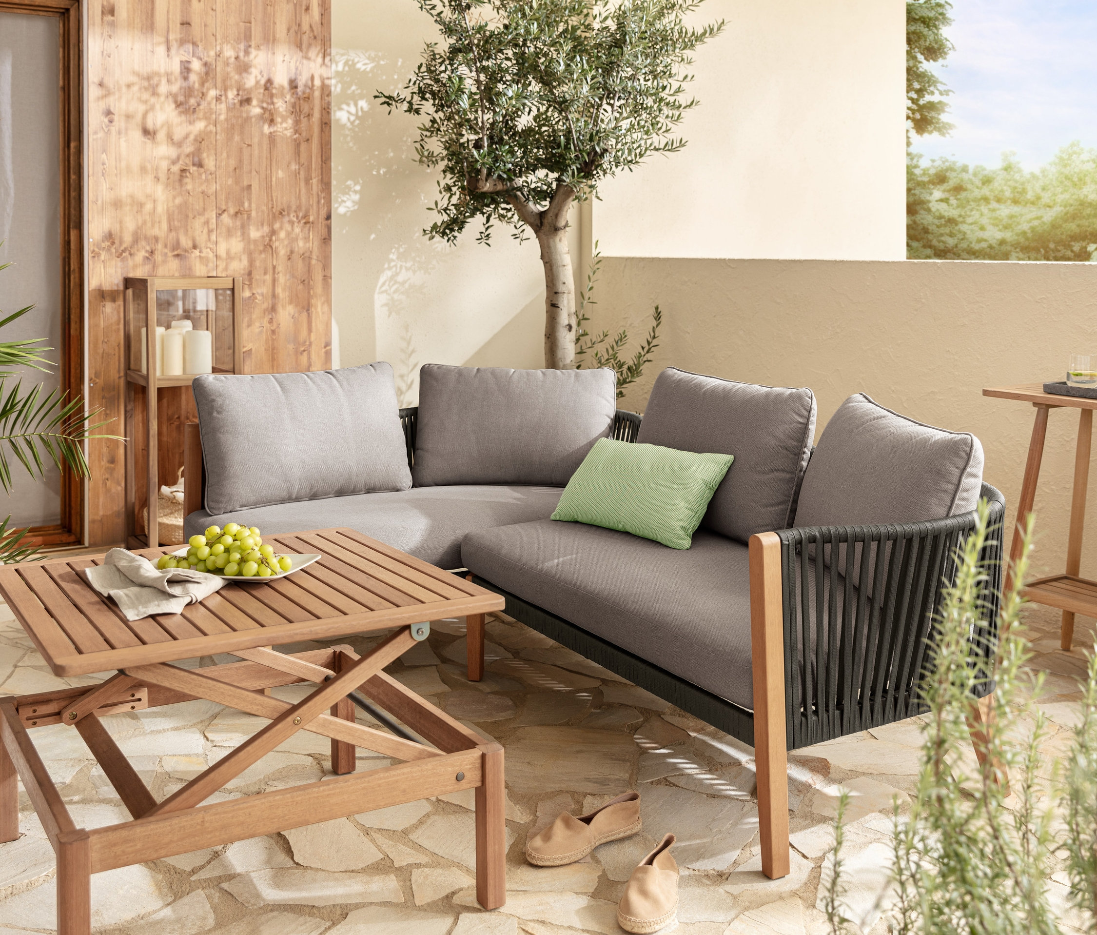 Flexible Lounge-Ecke mit Textilgeflecht, Couchtisch »Lenja« mit höhenverstellbarer Tischplatte, 2 Outdoor-Kissen, dekoratives Windlicht mit Regalboden und Konsolentisch mit 2 Ebenen.
