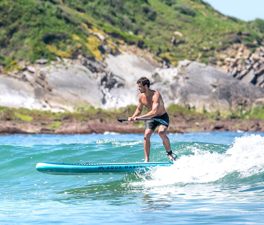 Mann paddelt auf einem Aqua Marina SUP Board »Beast« 10'6" auf den Wellen.