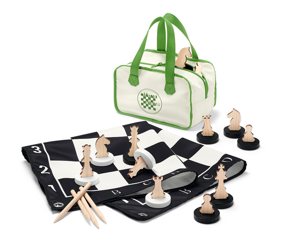 Ein XL-Schachspiel ist mit hölzernen Schachfiguren und einer Tasche ausgebreitet.
