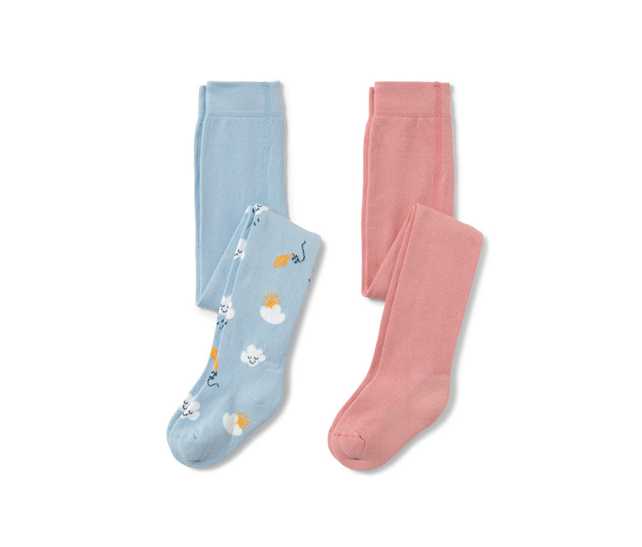 Zwei Kleinkind-Strumpfhosen, eine hellblau mit Wolken-, Sonnen- und Drachenmuster, die andere rosa.